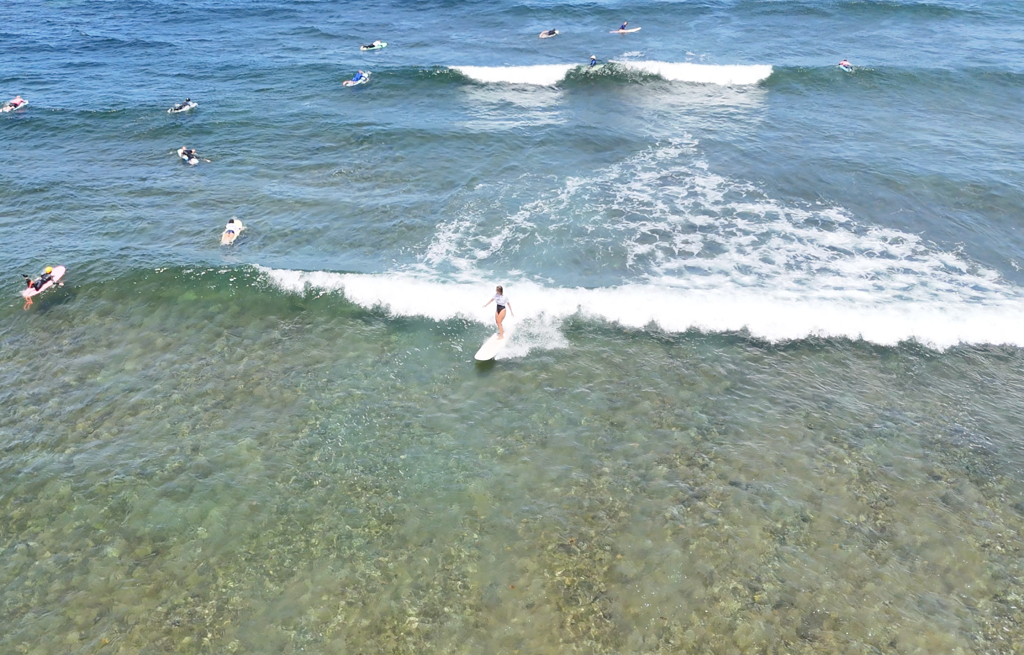 Intermediate surfers training on a reef spot